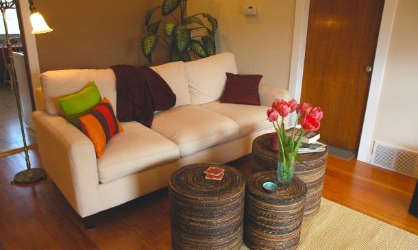 Couch with cushions and coffee table made from barrels