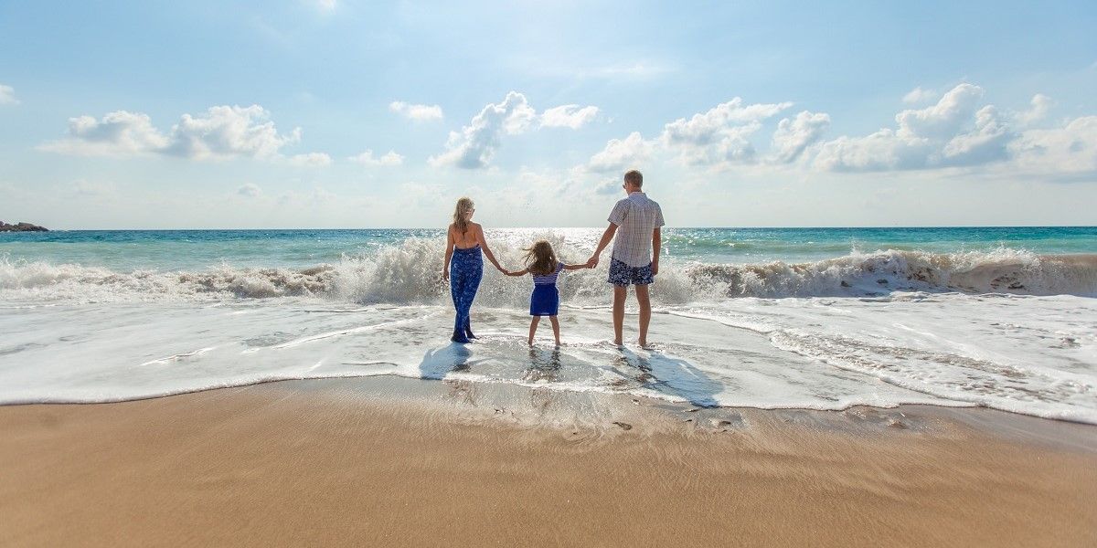 Parenting Ideas Summer Holidays Parents with Child at the beach