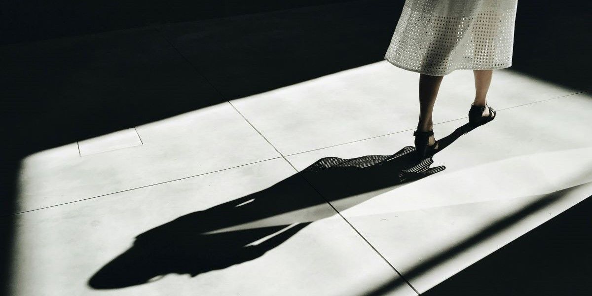 woman walking away with a shadow behind her