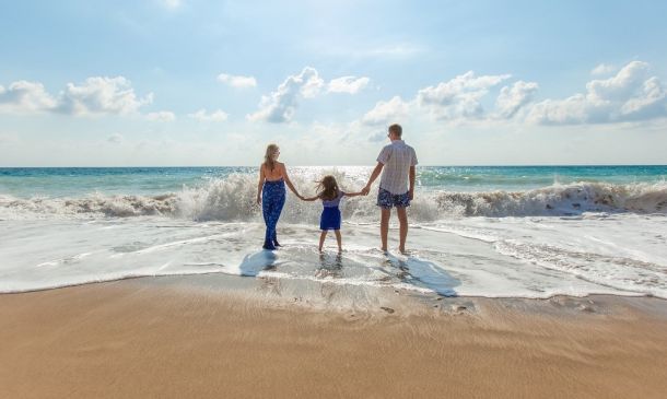 Parenting Ideas Summer Holidays Parents with Child at the beach